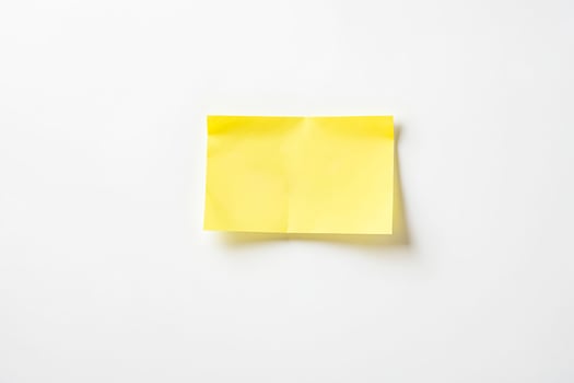 Blank Yellow Sticky Note on White Background photo