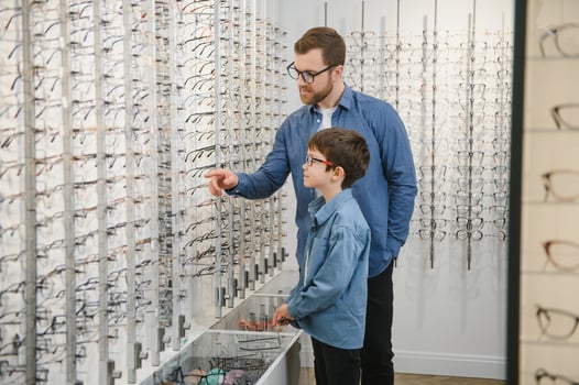 Father with cute son. Family buy glasses photo