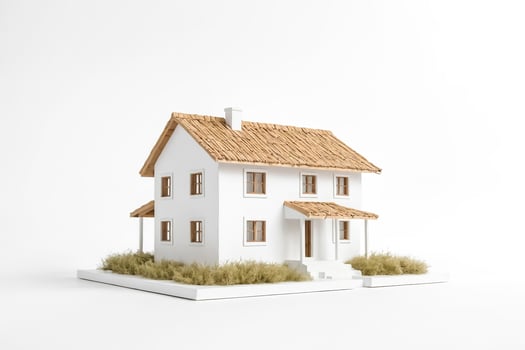 Miniature House with Thatched Roof and White Walls photo