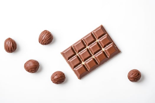 Chocolate bar and truffles on white background photo