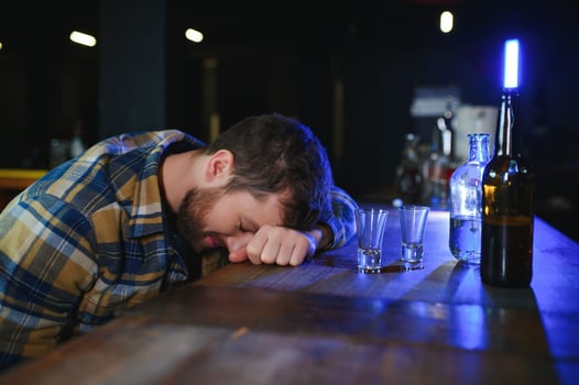 Sad man sitting at bar counter, alcohol addiction photo