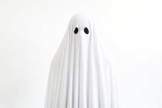 Ghostly Figure in White Sheet with Eye Holes photo