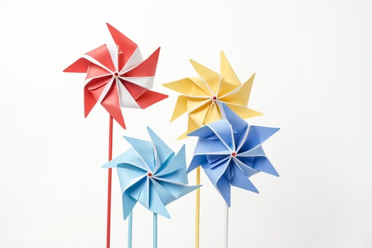 Colorful Paper Windmills on White Background photo