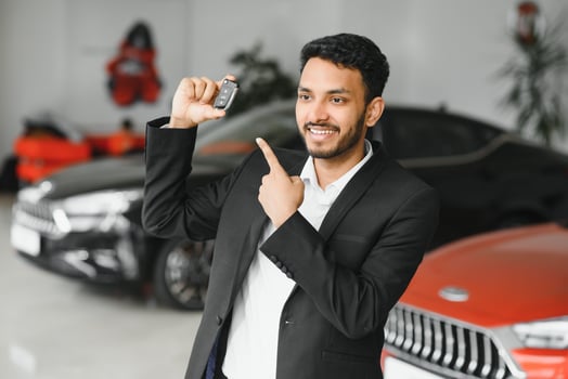 indian cheerful car salesman at showroom. photo