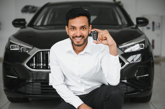 Closeup portrait happy, smiling, young man, buyer showing keys of his new car photo