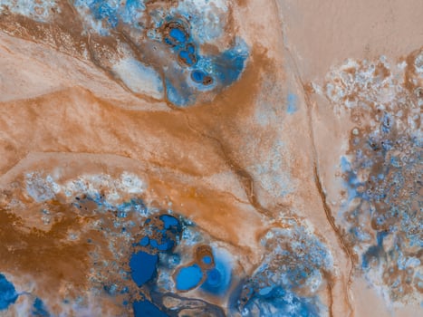 Aerial View of Icelandic Landscape with Blue Pools and Brown Rock Formations photo