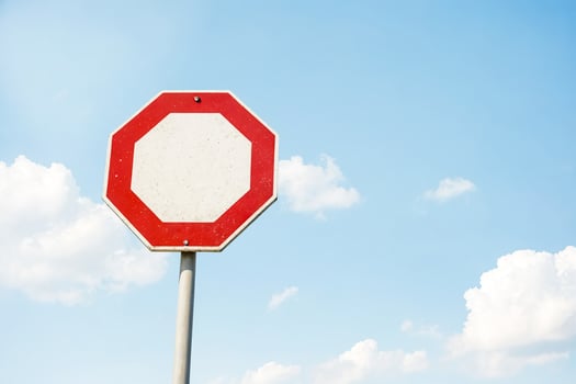 Stop sign against blue sky photo