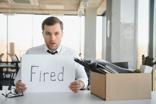 Sad Fired. Let Go Office Worker Packs His Belongings into Cardboard Box and Leaves Office. Workforce Reduction, Downsizing, Reorganization, Restructuring, Outsourcing. Mass Unemployment Market Crisis photo