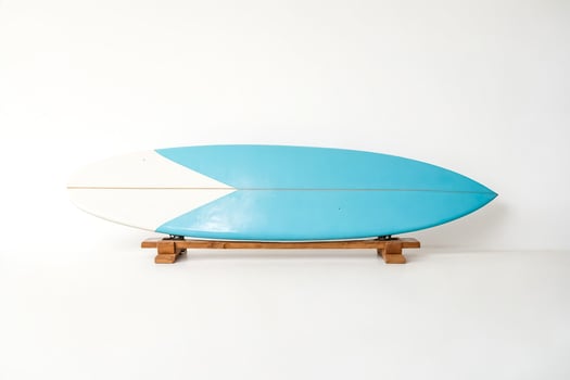 Vintage Surfboard on Wooden Stand photo