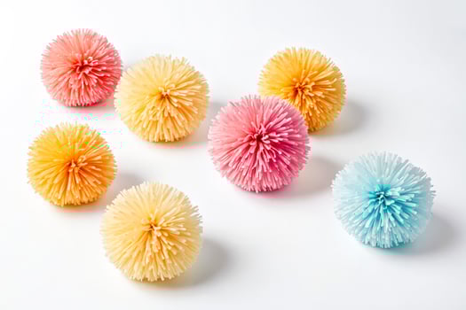 Colorful Paper Pom Poms on White Background photo