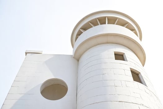 White lighthouse tower with round window photo