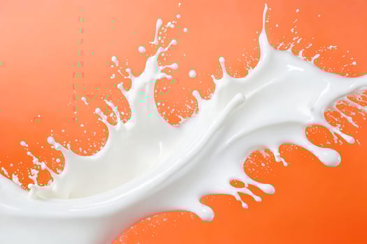 Milk Splash on Orange Background photo