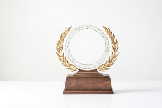 Gold Trophy with Laurel Wreath on White Background photo