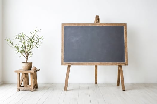 Blank Blackboard on Wooden Easel in White Room photo