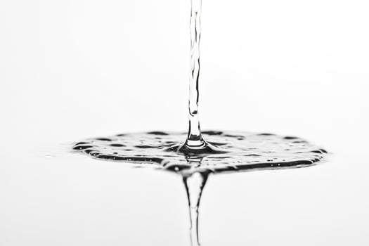 Water Droplet Splashing Into Still Water photo