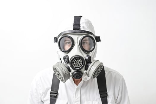 Man wearing gas mask and white coveralls photo