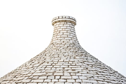 White Stone Conical Roof of a Traditional Trulli House photo