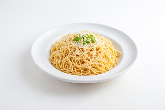 Spaghetti with Cheese and Basil on a White Plate photo