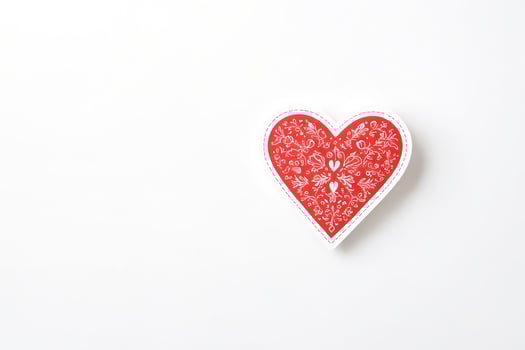 Red Heart with White Floral Pattern on White Background photo