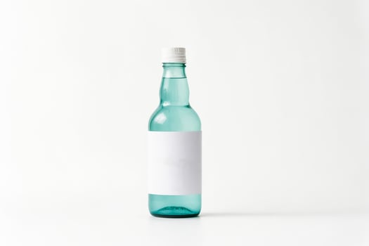 Glass Bottle With Blank Label On White Background photo