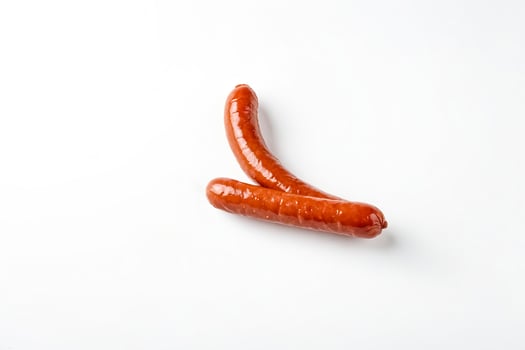 Two Smoked Sausages on White Background photo