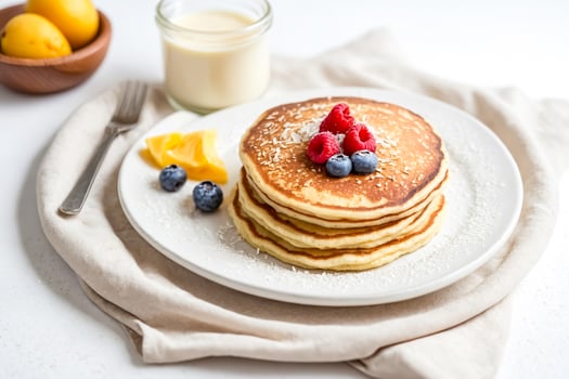 Stack of Pancakes with Coconut Flakes, Raspberries, and Blueberries photo