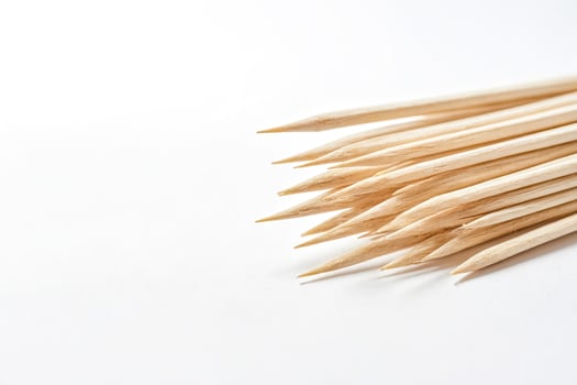 Close-up of wooden skewers on white background photo