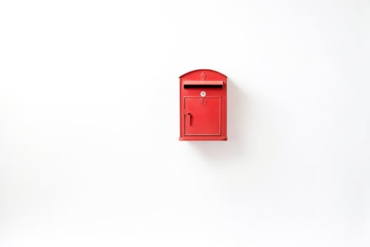 Red Postbox on a White Wall photo