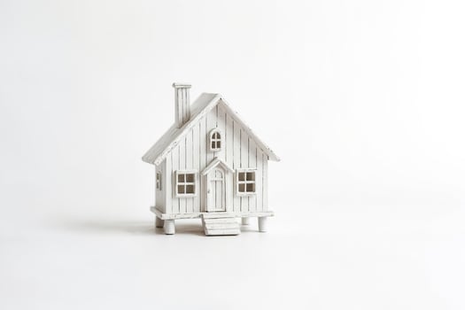 Small white wooden house on white background photo