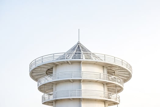 White tower with circular balconies against a clear sky photo
