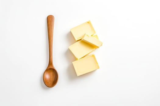 Wooden Spoon and Butter on White Background photo