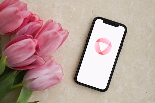 KYIV, UKRAINE - FEBRUARY 23, 2024 Open logo of famous dating website or app on iPhone display photo