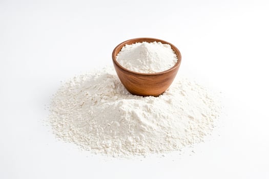 Wooden bowl with white flour on white background photo