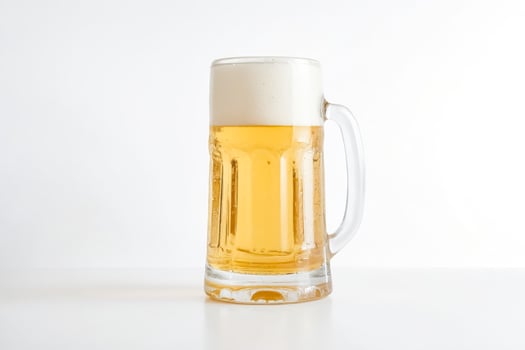 Glass of Beer on White Background photo