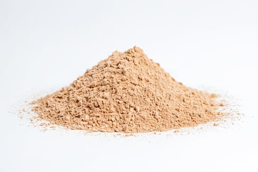 Pile of Brown Powder on a White Background photo