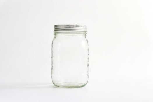 Empty Glass Jar with Silver Lid on White Background photo