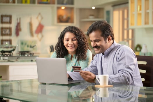 Hubby And Wifey Shopping Online Over Laptop At Home photo
