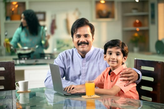 Dad And Son Smiling While Looking At Camera Screen photo