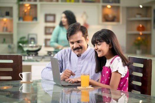 Father Teaching Daughter How To Use Laptop photo