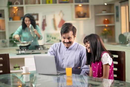 Daddy And Daughter While Watching On Laptop photo