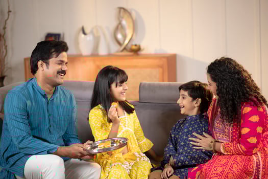 Loving Sister Feeding Laddu To Her Brother During Raksha Bandhan Festival photo