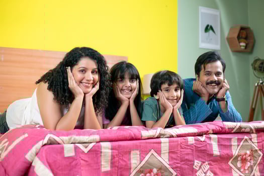 Modern Family Keeping Hand On Cheek While Looking At Camera photo
