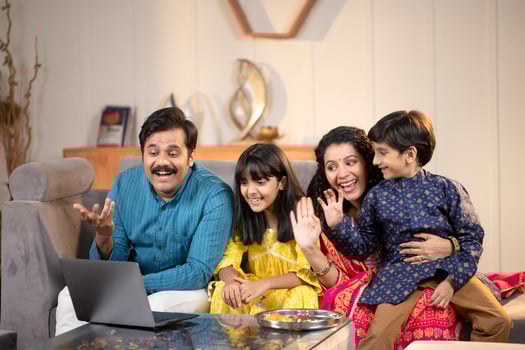 Smiling Family Chatting With Friends By Call On Raksha Bandhan At Home photo