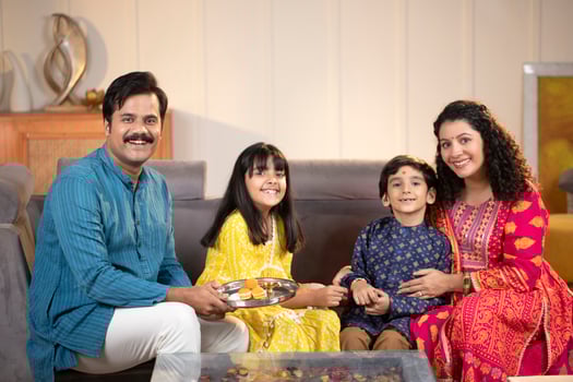 Loving Parents With Kids Posing In Front Of Camera In Traditional Wear photo