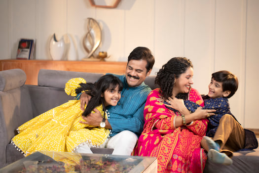 Family Having Fun While Sitting Together On Sofa In Living Room photo