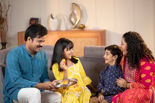 Happy Sister Feeding Her Brother During Rakhi photo