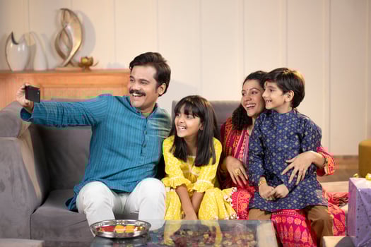Father And Mother With Kids Taking Pictures With Mobile Phone At Home photo