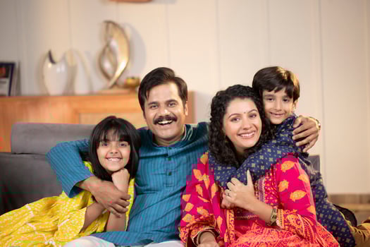 Nuclear Family In Taditional Wear Posing In Front Of Camera photo