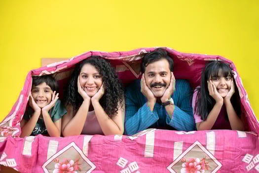 Happy Family Lying Under A Bedsheet photo