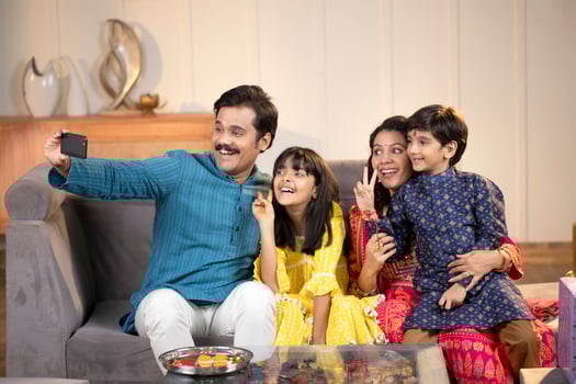 Father Mother Son And Daughter Celebrating Raksha Bandhan And Taking Selfie On Phone photo